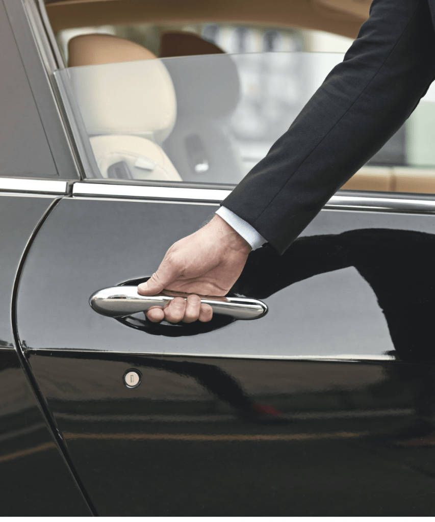 A chauffeur opening the door of a limousine, symbolising women´s way to a peer society membership by submitting their Capsule Community application.