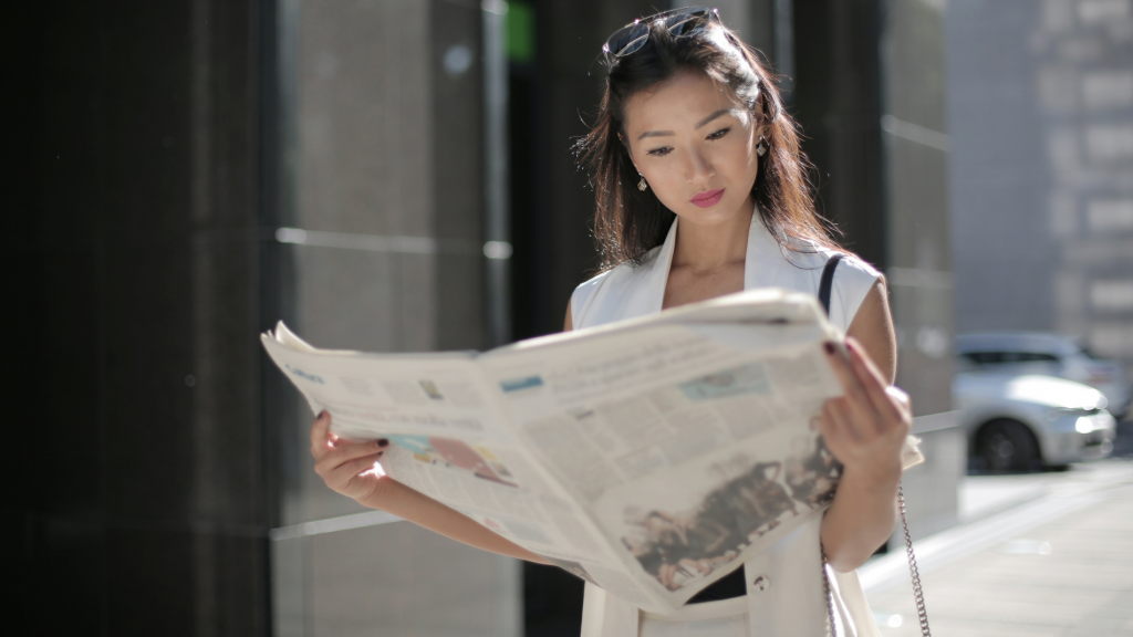 Woman reading a newspaper—shortlisted tips to navigate the infodemic and make sense of the news