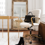 A feminine office with a desk and a golden mirror in the back, the setting is ready to take the 30-minute strategy call for mentoring options