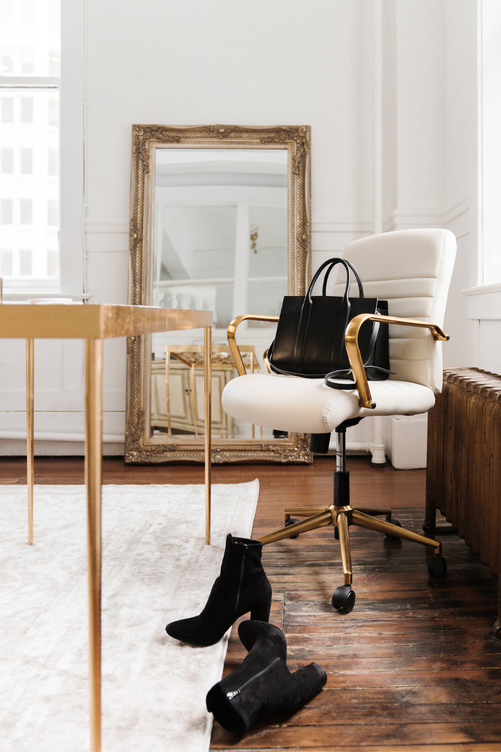 A feminine office with a desk and a golden mirror in the back, the setting is ready to take the 30-minute strategy call for mentoring options
