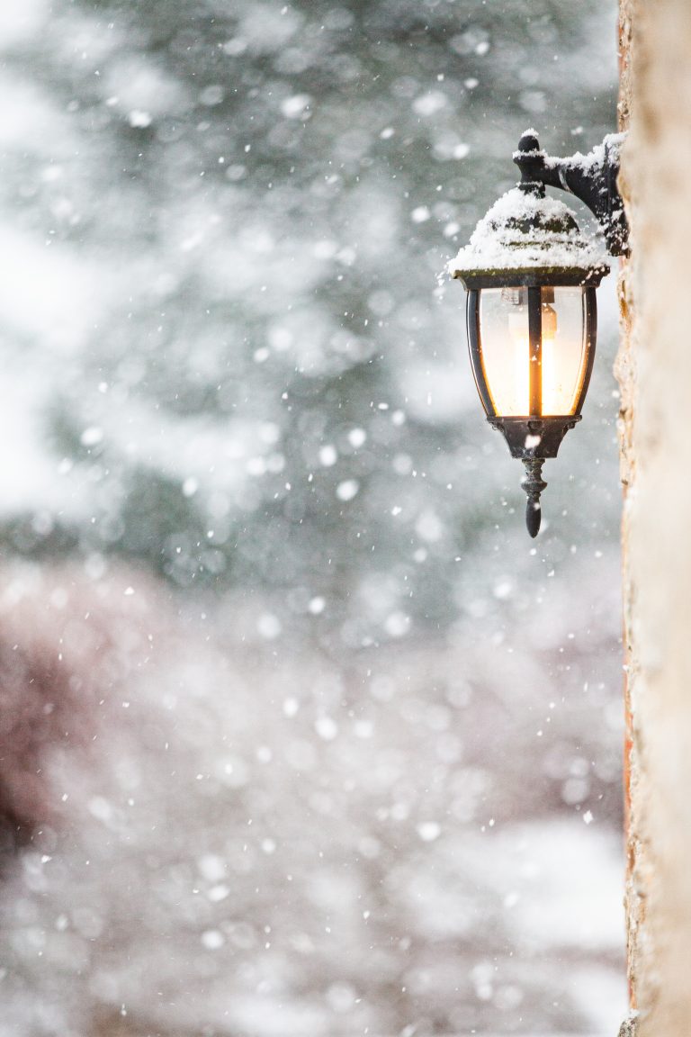 A glowing lantern in a snow-filled winter scene—introducing the December–January Curated Letter, curated to build confidence and help you become the most interesting woman in the room