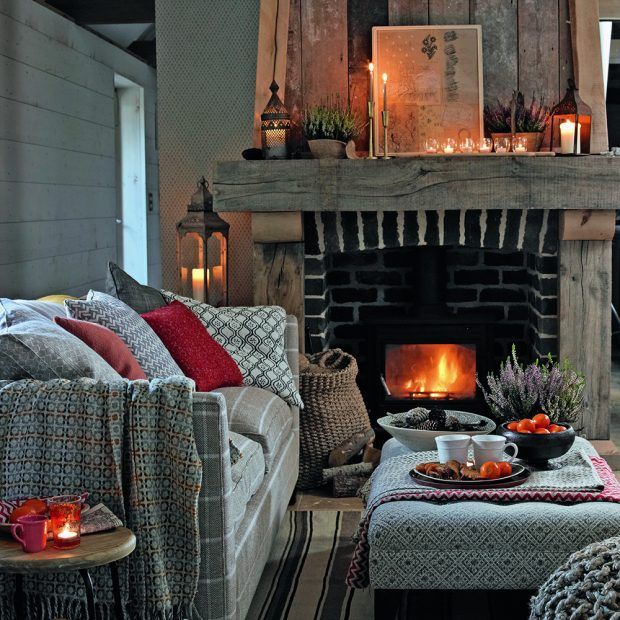 A warm, inviting living space with sofas, tea, and candlelight—capturing the mood of the Jan–Feb Curated Letter, where confidence grows in comfort and style.
